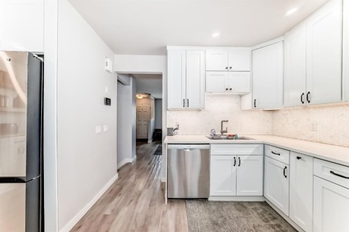 11-800 Bowcroft Place, Cochrane, AB - Indoor Photo Showing Kitchen With Stainless Steel Kitchen