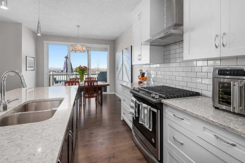 49 Tuscany Ridge Circle Nw, Calgary, AB - Indoor Photo Showing Kitchen With Stainless Steel Kitchen With Double Sink With Upgraded Kitchen