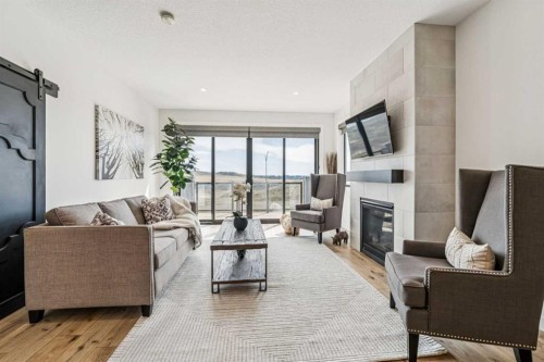 220 Precedence View, Cochrane, AB - Indoor Photo Showing Living Room With Fireplace