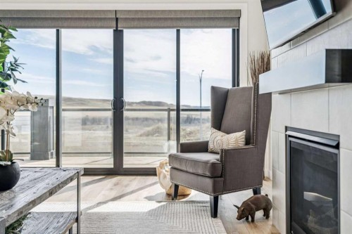 220 Precedence View, Cochrane, AB - Indoor Photo Showing Other Room With Fireplace