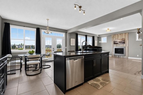 129 Windford Park Sw, Airdrie, AB - Indoor Photo Showing Kitchen With Fireplace