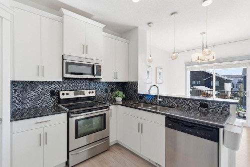 11 Evanscrest Way Nw, Calgary, AB - Indoor Photo Showing Kitchen With Stainless Steel Kitchen With Double Sink With Upgraded Kitchen
