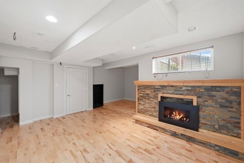 646 Everridge Drive Sw, Calgary, AB - Indoor Photo Showing Other Room With Fireplace