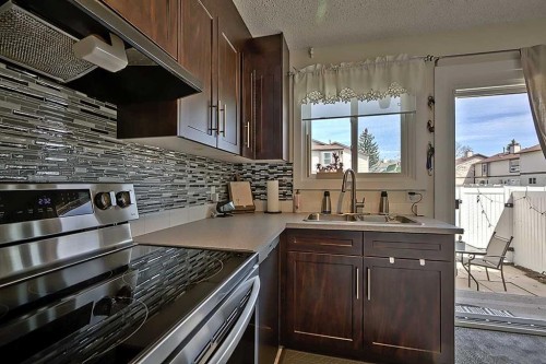72 Deerpoint Road Se, Calgary, AB - Indoor Photo Showing Kitchen With Double Sink