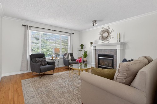 57 Bridlewood Manor Sw, Calgary, AB - Indoor Photo Showing Living Room With Fireplace