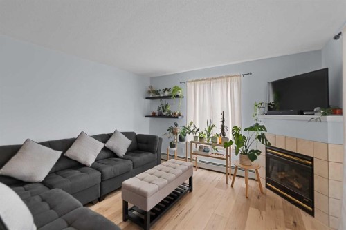 2219-2600 66 Ne, Calgary, AB - Indoor Photo Showing Living Room With Fireplace