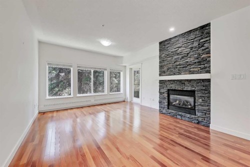 120-20 Discovery Ridge Close Sw, Calgary, AB - Indoor Photo Showing Living Room With Fireplace