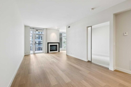 416-222 Riverfront Avenue Sw, Calgary, AB - Indoor Photo Showing Living Room With Fireplace