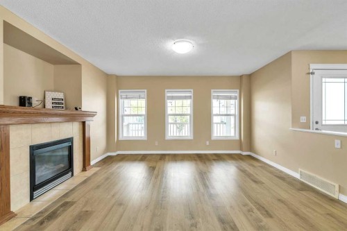 247 Evermeadow Avenue Sw, Calgary, AB - Indoor Photo Showing Living Room With Fireplace