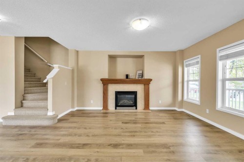 247 Evermeadow Avenue Sw, Calgary, AB - Indoor Photo Showing Living Room With Fireplace