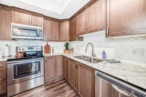 1212-3727 Sage Hill Drive Nw, Calgary, AB - Indoor Photo Showing Kitchen With Stainless Steel Kitchen With Double Sink With Upgraded Kitchen