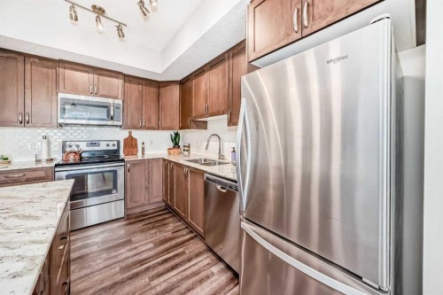 1212-3727 Sage Hill Drive Nw, Calgary, AB - Indoor Photo Showing Kitchen With Stainless Steel Kitchen With Double Sink With Upgraded Kitchen