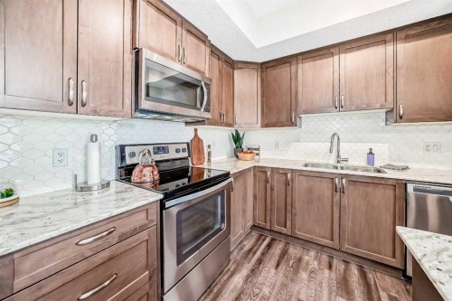 1212-3727 Sage Hill Drive Nw, Calgary, AB - Indoor Photo Showing Kitchen With Stainless Steel Kitchen With Double Sink