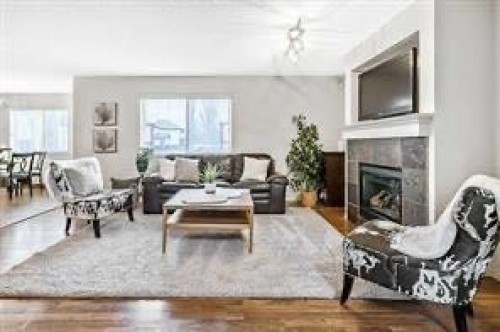 105 Cimarron Park Circle, Okotoks, AB - Indoor Photo Showing Living Room With Fireplace