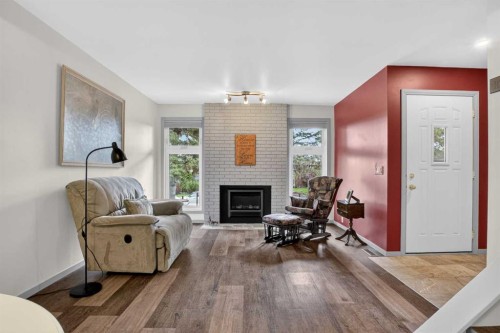 23 Bermuda Place Nw, Calgary, AB - Indoor Photo Showing Living Room With Fireplace