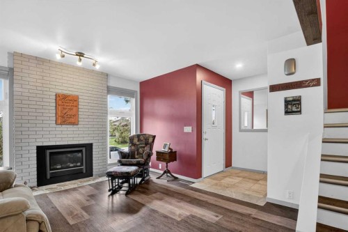 23 Bermuda Place Nw, Calgary, AB - Indoor Photo Showing Living Room With Fireplace
