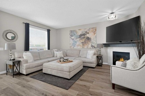 176 Chapalina Heights Se, Calgary, AB - Indoor Photo Showing Living Room With Fireplace
