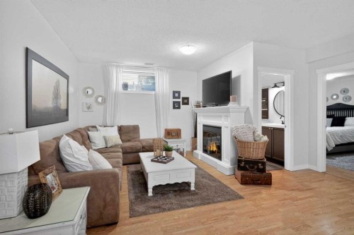 176 Chapalina Heights Se, Calgary, AB - Indoor Photo Showing Living Room With Fireplace