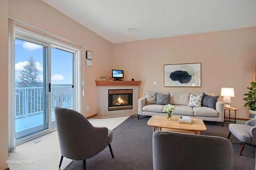 78 Hamptons Link Nw, Calgary, AB - Indoor Photo Showing Living Room With Fireplace