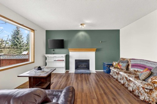 100 Tuscany Way Nw, Calgary, AB - Indoor Photo Showing Living Room With Fireplace