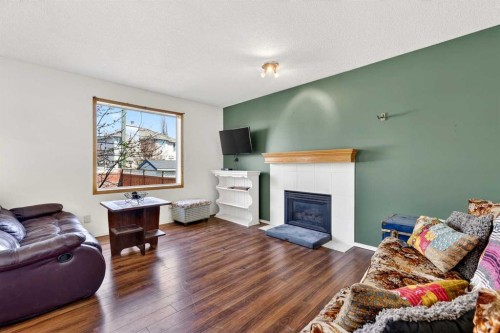 100 Tuscany Way Nw, Calgary, AB - Indoor Photo Showing Living Room With Fireplace