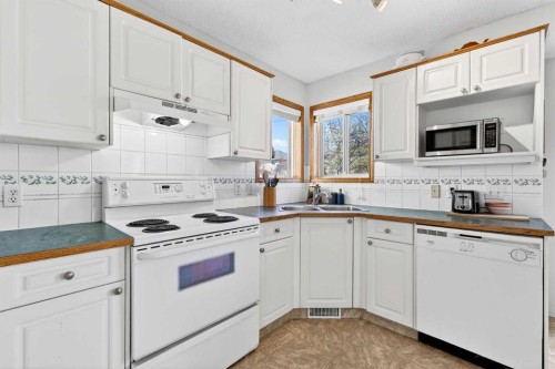 100 Tuscany Way Nw, Calgary, AB - Indoor Photo Showing Kitchen With Double Sink