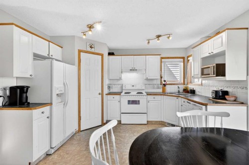 100 Tuscany Way Nw, Calgary, AB - Indoor Photo Showing Kitchen With Double Sink