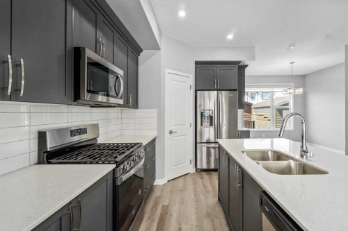 109 Dawson Drive, Chestermere, AB - Indoor Photo Showing Kitchen With Double Sink With Upgraded Kitchen