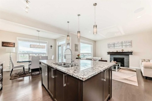91 Nolanfield Crescent Nw, Calgary, AB - Indoor Photo Showing Kitchen With Fireplace With Double Sink With Upgraded Kitchen