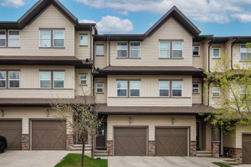 17-28 Heritage Drive, Cochrane, AB - Outdoor With Facade