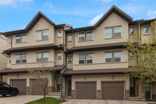 17-28 Heritage Drive, Cochrane, AB - Outdoor With Facade