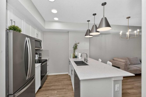 218-140 Mahogany Street Se, Calgary, AB - Indoor Photo Showing Kitchen With Stainless Steel Kitchen With Double Sink With Upgraded Kitchen