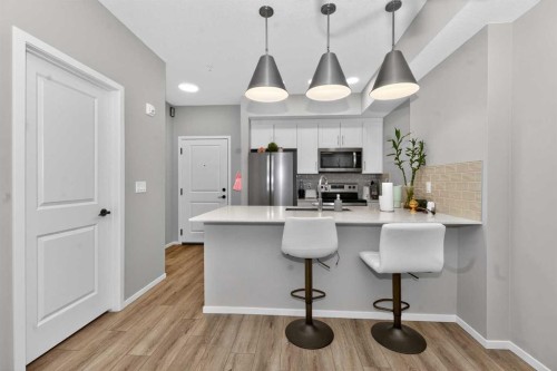 218-140 Mahogany Street Se, Calgary, AB - Indoor Photo Showing Kitchen With Stainless Steel Kitchen With Upgraded Kitchen