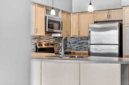 312-205 Riverfront Avenue Sw, Calgary, AB - Indoor Photo Showing Kitchen With Double Sink