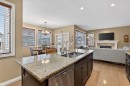 2 Ranchers Green, Okotoks, AB  - Indoor Photo Showing Kitchen With Fireplace With Double Sink 