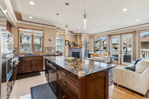 4538 Montgomery Avenue Nw, Calgary, AB - Indoor Photo Showing Kitchen With Fireplace With Double Sink With Upgraded Kitchen
