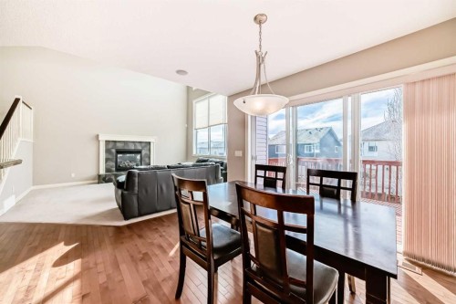 455 Hidden Creek Boulevard Nw, Calgary, AB - Indoor Photo Showing Dining Room With Fireplace
