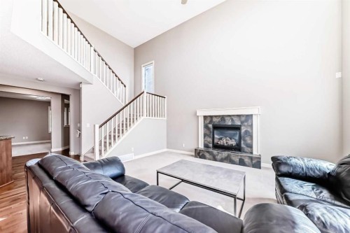 455 Hidden Creek Boulevard Nw, Calgary, AB - Indoor Photo Showing Living Room With Fireplace