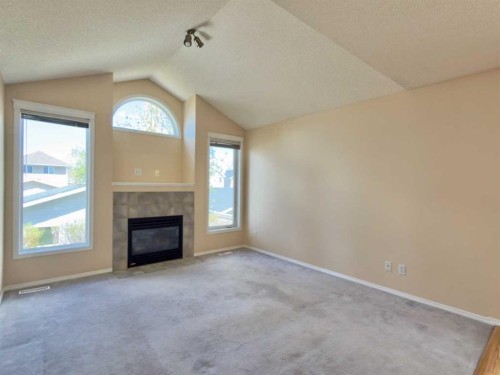 206 Tuscany Drive Nw, Calgary, AB - Indoor Photo Showing Living Room With Fireplace