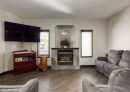 244 Stonegate Close Nw, Airdrie, AB  - Indoor Photo Showing Living Room With Fireplace 
