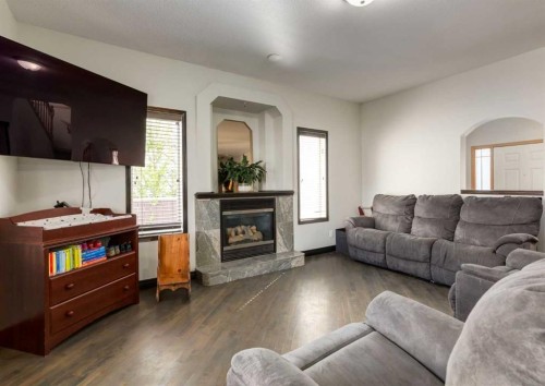 244 Stonegate Close Nw, Airdrie, AB - Indoor Photo Showing Living Room With Fireplace