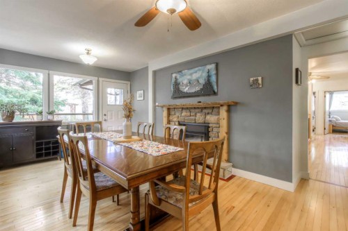 2519 Cherokee Drive Nw, Calgary, AB - Indoor Photo Showing Dining Room With Fireplace