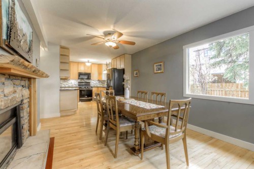 2519 Cherokee Drive Nw, Calgary, AB - Indoor Photo Showing Dining Room With Fireplace