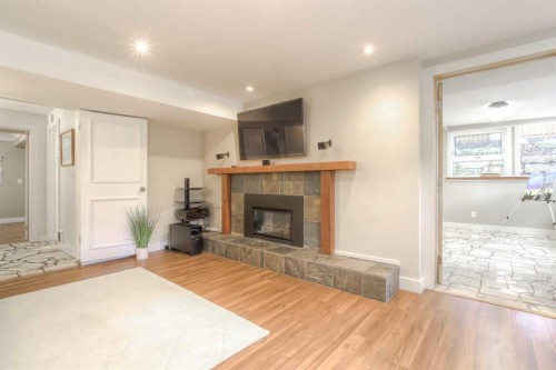 2519 Cherokee Drive Nw, Calgary, AB - Indoor Photo Showing Living Room With Fireplace