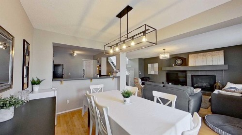 17 Sunset Heights, Cochrane, AB - Indoor Photo Showing Dining Room With Fireplace