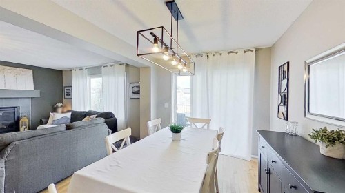 17 Sunset Heights, Cochrane, AB - Indoor Photo Showing Dining Room With Fireplace