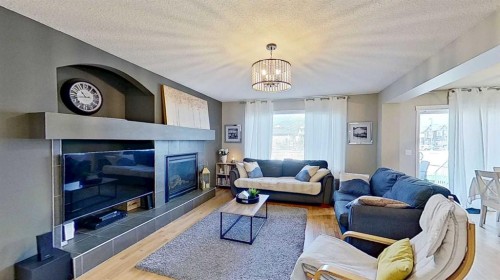 17 Sunset Heights, Cochrane, AB - Indoor Photo Showing Living Room With Fireplace