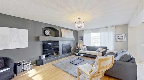 17 Sunset Heights, Cochrane, AB - Indoor Photo Showing Living Room With Fireplace