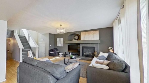 17 Sunset Heights, Cochrane, AB - Indoor Photo Showing Living Room With Fireplace