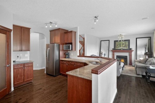 32 Evanspark Circle Nw, Calgary, AB - Indoor Photo Showing Kitchen With Fireplace With Stainless Steel Kitchen With Double Sink